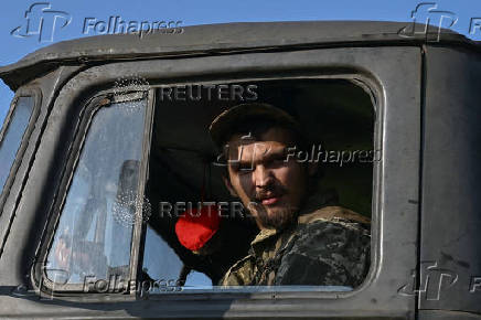 Ukrainian serviceman looks out of a cabin of a multiple rocket launcher before firing towards Russian troops on a front line in Zaporizhzhia region