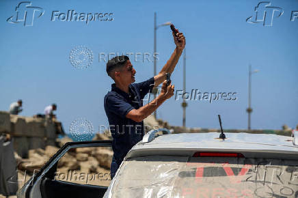 Palestinians attempt to access the internet using eSIMs, in Gaza City