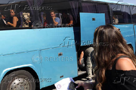 A passenger from the Crown Iris a cruise ship sits in a bus, at the port of Larnaca