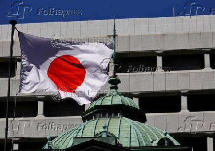 FILE PHOTO: Japanese national flag waves at the Bank of Japan building in Tokyo