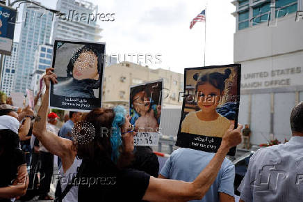 People take part in a protest against what organizers call 