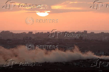 Smoke rises from Gaza as the sun sets, as seen from the Israeli side of the Israel-Gaza border