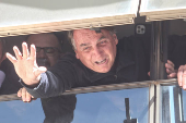 Bolsonaro acena para apoiadores pela janela do Brasil 21, sedo do PL