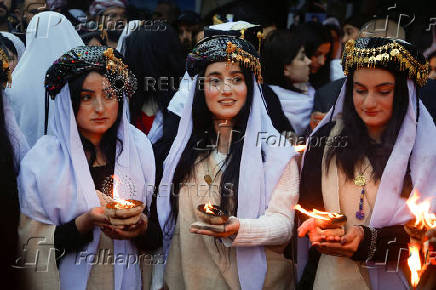 Iraqi Yazidis attend a ceremony on the occasion of Red Wednesday, to celebrate the Yazidi New Year, at Lalish temple in Shekhan District near Duhok province