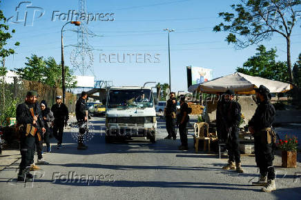 Syrian security forces stand together, following deadly clashes between Sunni fighters against armed Druze residents in Jaramana
