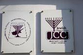 Signs are seen at the entrance of the Jewish synagogue in Larnaca