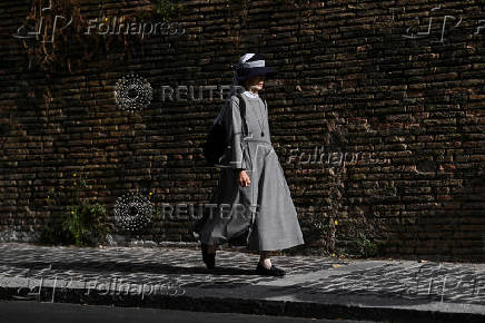 A nun walks near the Vatican after the election of Pope Leo XIV, in Rome
