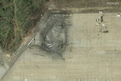 A satellite image shows a cleanup of debris in the aftermath of a drone strike at the Olenya air base