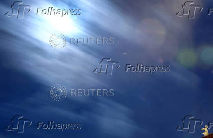 A clay figure of a sleepwalker is seen on a rooftop during the annual Perseid meteor shower in Hanau