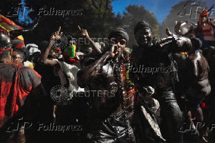 Revelers attend J'ouvert celebration on the day of the annual West Indian Day parade in the Brooklyn borough of New York