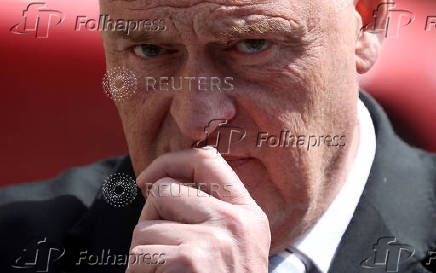 Britain?s Reform Party MP Anderson looks on as leader Farage speaks with journalists outside Houses of Parliament in London