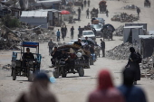Displaced Palestinians flee their homes in the town of Beit Lahia, north of Gaza City,
