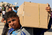 Palestinians seeking aid gather near an aid distribution site run by the U.S.-backed Gaza Humanitarian Foundation, in Rafah