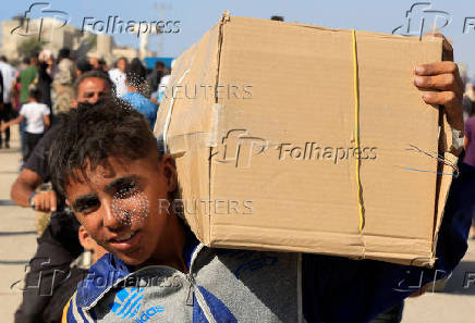 Palestinians seeking aid gather near an aid distribution site run by the U.S.-backed Gaza Humanitarian Foundation, in Rafah