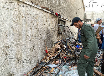 A member of the Syrian security force inspects the damage after a blast rocked the Mar Elias Church in the Dweila neighbourhood of Damascus