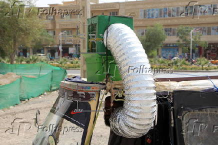 Taxi drivers install locally made air coolers to beat the heat in Kandahar