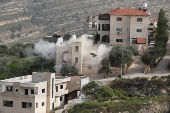 Smoke rises after the Israeli army blew up the house of a Palestinian assailant in Deir Ibzi town, near Ramallah