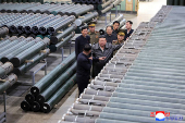 North Korea's leader Kim Jong Un visits a factory that makes shells and machinery