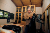 FILE PHOTO: Presidential candidate of ruling party Frente Amplio former left-wing guerrilla fighter Jose Mujica puts his clothes in his bedroom in his farm in the outskirts of  Montevideo