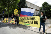 Activists of Greenpeace attend a protest near the Russian Embassy in Paris