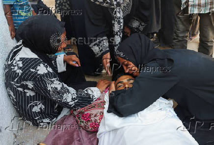 Mourners attend the funeral of Palestinians who were killed, according to medics, in Israeli fire, at Al-Shifa hospital, in Gaza City