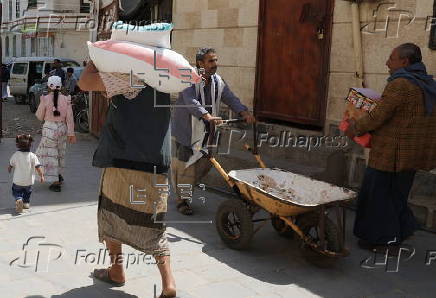 Yemenis receive food aid in Sana'a, distributed by Mona Relief agency