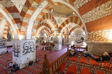 People rest before the Friday prayers at the Old Mosque in Edirne