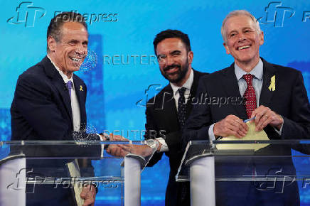FILE PHOTO: Cuomo and Mamdani shake hands after a debate in New York