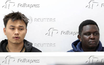 Vietnamese national Duh Hung Nyugen and Kenyan Dennis Ng'ang'a look on during the hearing of their case after they pleaded guilty to illegal possession and trafficking of garden ants, in Nairobi