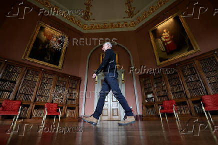 A staff member walks past a collection of rehung paintings in the renovated Long Gallery which is unveiled following a major restoration of Castle Howard, in York