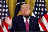 U.S. President Trump signs a resolution at the White House