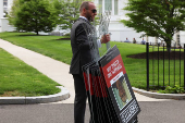 Peter Navarro speaks to the media outside the White House