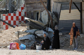 Palestinians carry their belongings after Israel's decision to demolish their homes in Nur Shams camp