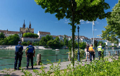 Members of the police patrol along the banks of the Rhine river during the Eurovision Song Contest in Basel