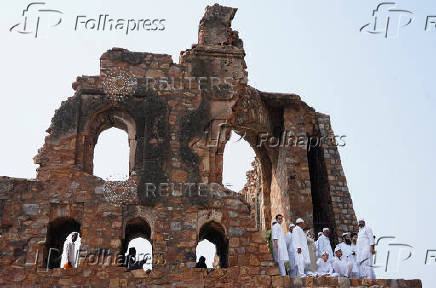 Muslims stand amidst the ruins of Feroz Shah Kotla mosque after offering prayers on the occasion of Eid-al-Adha in New Delhi