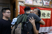 Chan Po-ying, chair of Hong Kong?s League of Social Democrats, hugs party member Jimmy Sham, recently released from prison, before a press conference to announce the party?s dissolution amid China?s national security law, in Hong Kong