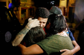 Arturo Suarez, who was held for months in an El Salvador prison, greets family members after his release, in Caracas