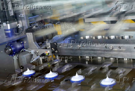 FILE PHOTO: Nivea tins are filled on a production line at the plant of German personal-care company Beiersdorf  in Hamburg