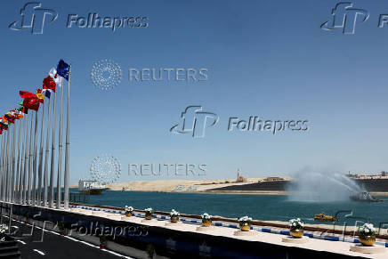 Egypt's Suez Canal Authority removes solid waste from the waters in the passage in Ismalia