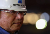 A worker wears a helmet with The Nippon Steel logo, inside the plate rolling mill area at the company's East Nippon Works Kimitsu Area plant in Kimitsu