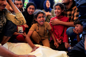 Funeral of a Palestinian killed, in what the Gaza health ministry says was Israeli fire near a distribution center in Rafah, at Nasser hospital in Khan Younis