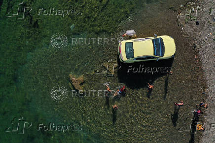 A drone view shows people enjoying in the Euphrates River during a hot day in Raqqa