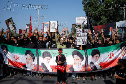 Shi'ite mourners raise their hands and shout slogans during a Muharram procession ahead of Ashura in Srinagar