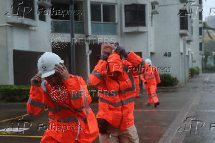 Workers brave strong winds as Typhoon Wipha approaches, in Hong Kong