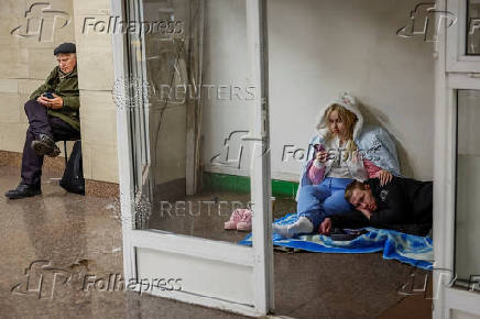 People take shelter inside a metro station during a Russian military strike in Kyiv