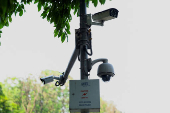 Installed Closed Circuit Television (CCTV) cameras are seen in a street in New Delhi