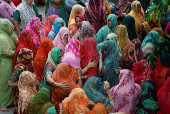 Family members and relatives mourn during the funeral of Chetnaba Chavda and her husband Ranvirsinh Chavda, in Ahmedabad