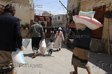 Yemenis receive food aid in Sana'a, distributed by Mona Relief agency