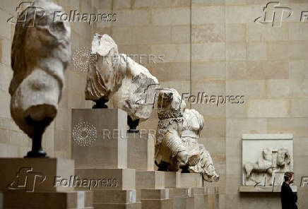 FILE PHOTO: A man looks at the Parthenon Marbles on show at the British Museum in London