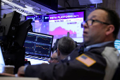 Traders work on the floor at the New York Stock Exchange, in New York City